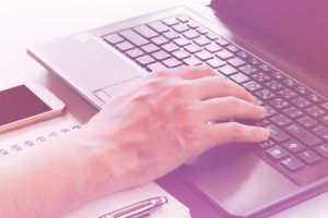 Typing a Company Blog Post Writer Uses Laptop For Blog Writing Service